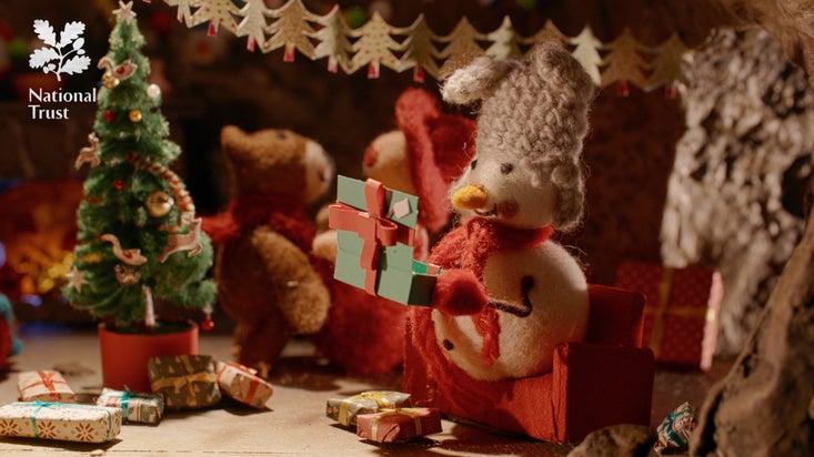 A snowman Christmas decoration opening a present